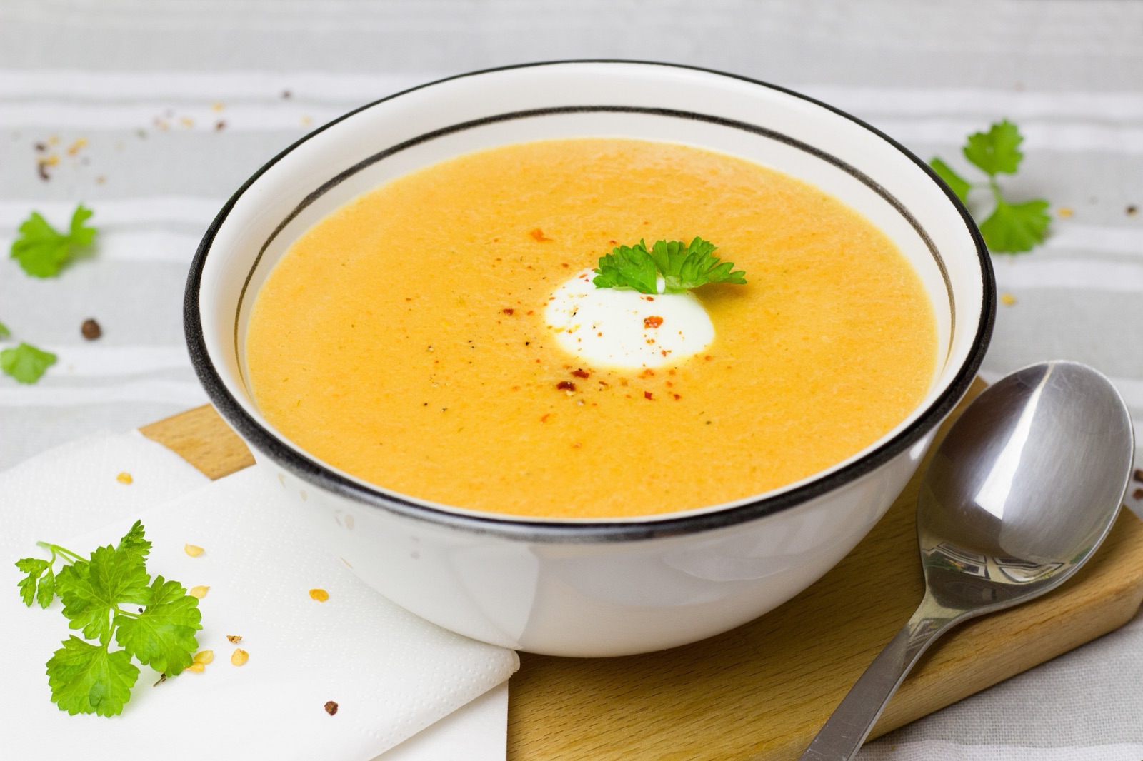 A bowl of pumpkin soup finished with a drizzle of oil, one reference among many in its category